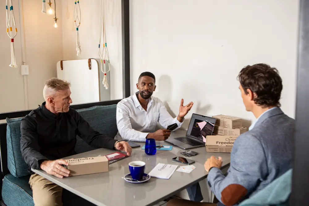 Business team discussing company expenses and prepaid card controls in a meeting